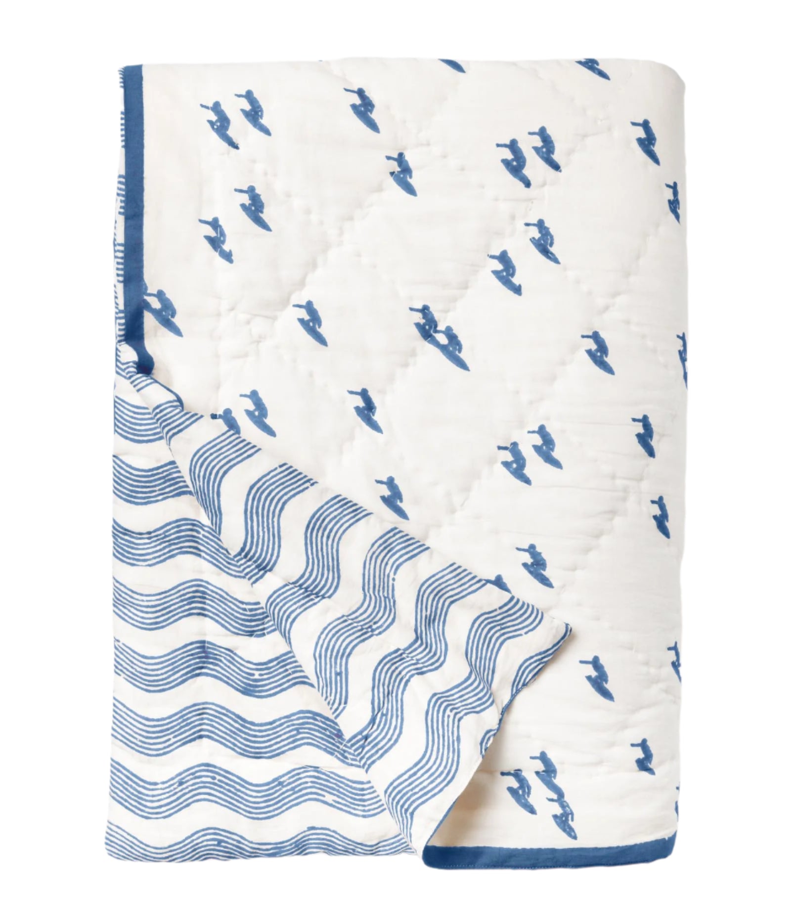 The Averylily Surfer Bedding Collection features a folded quilt with blue surfer silhouettes on white and blue wavy lines on the reverse, inspired by Hawaiian quilts and crafted from soft cotton voile.