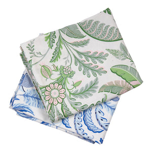 Two folded Addison Ross Palm Beach Tablecloths—one with a green and pink botanical pattern, the other with a blue floral design—are stacked on a white background.
