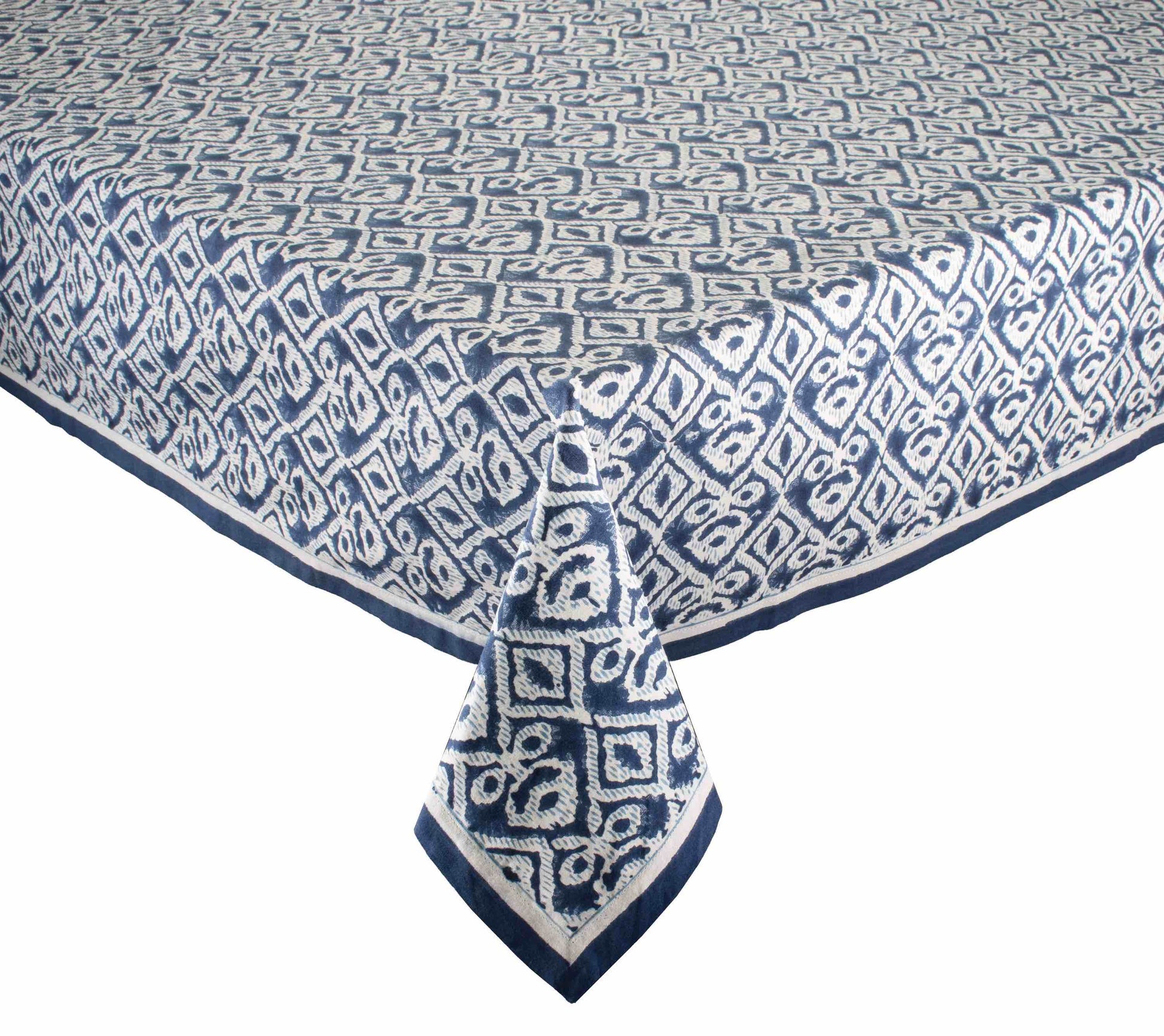 The Alfresco Tablecloth by Kim Seybert features a blue and white geometric design inspired by traditional Indian block printing and is made from 100% cotton.