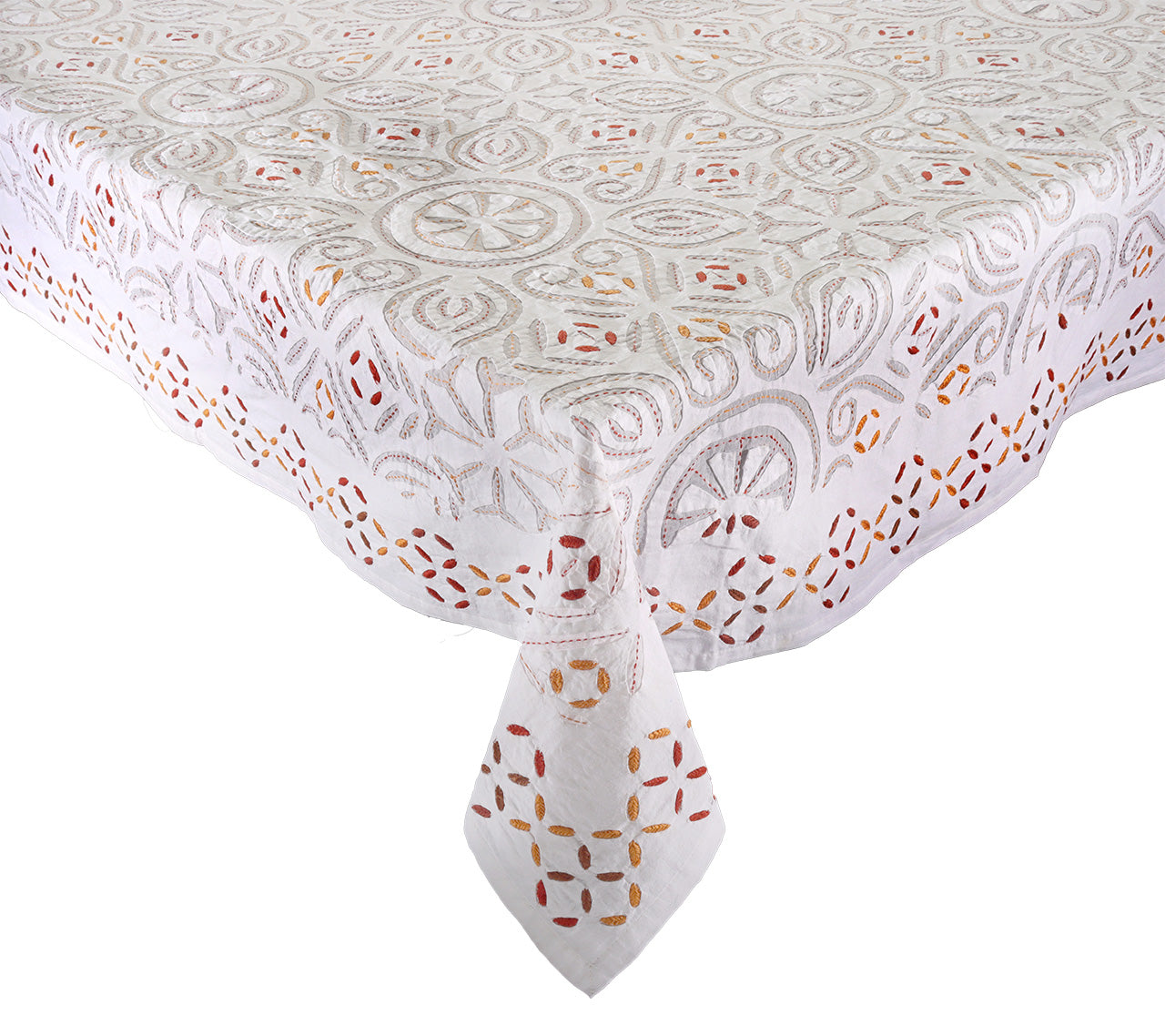 The Kim Seybert Malta Tablecloth Collection features a rectangular white tablecloth with elegant cutwork and decorative geometric and floral patterns in shades of grey, gold, and red.
