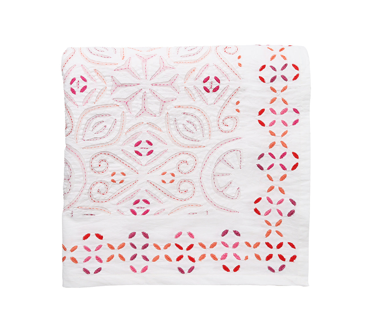 The Malta Tablecloth Collection by Kim Seybert features a folded white tablecloth with pink and red embroidered geometric and floral patterns, perfect for elegant table décor.