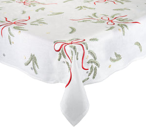 Merry and Bright Tablecloth featuring white embroidery with green pine boughs, gold dots, and red ribbons.