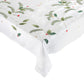 The Kim Seybert Christmas Carol Table Linen Collection features a white linen tablecloth embroidered with green pine branches, holly leaves, red berries, and gold dots—perfect for a festive holiday table setting.