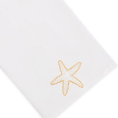 The Haute Home Playful Starfish Bath Collection includes a white linen napkin adorned with a beige and white embroidered starfish in one corner, shown on a plain background—a subtle yet elegant addition to your home décor.