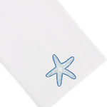 Elevate your home décor with the Playful Starfish Bath Collection from Haute Home: a white premium linen fabric napkin featuring a blue starfish embroidered in one corner, combining elegance with coastal charm.