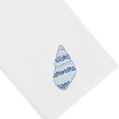 Crafted from white Italian linen and adorned with a blue speckled conch illustration near the corner, Haute Home’s Speckled Conch Coaster & Bath Collection brings a touch of coastal elegance to your linen home decor.