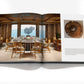 An open spread of "Terence Disdale: My Art of Yacht Design" by Assouline showcases a modern dining room with ocean views inspired by superyacht elegance, while the facing page features a fossil and descriptive text.