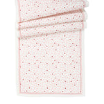 The Juliska "Love You More" Table Runner features a rectangular white design with red and pink small heart patterns and a thin red border—perfect for festive table decor.
