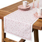 The Juliska Love You More Table Runner, paired with pink heart-themed plates, cups, saucers, and pink candle holders, creates the perfect festive table decor.