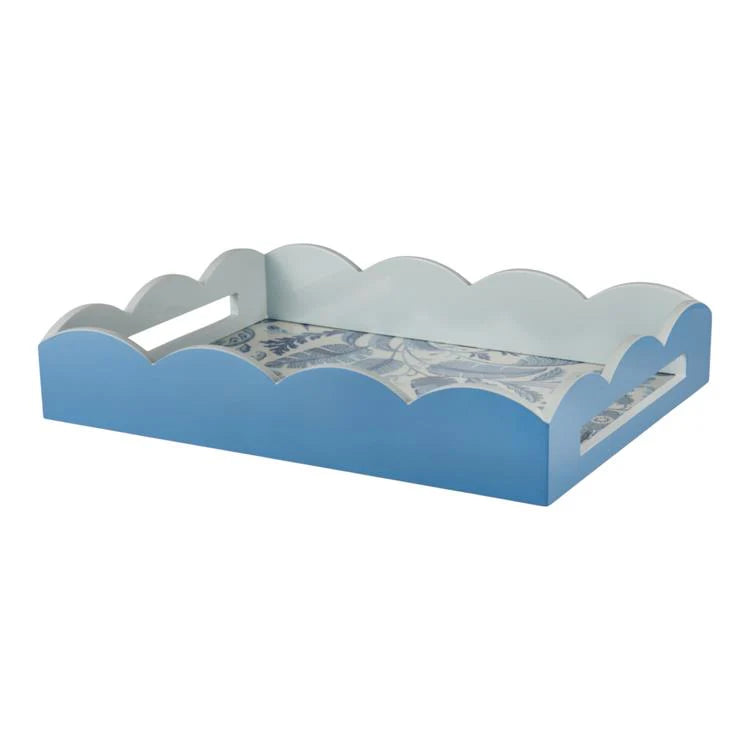 The Palm Beach Scallop Tray Collection by Addison Ross features a rectangular blue tray with scalloped edges, cutout handles, and a decorative blue and white floral base—ideal for fans of high-gloss lacquer trays with timeless style.