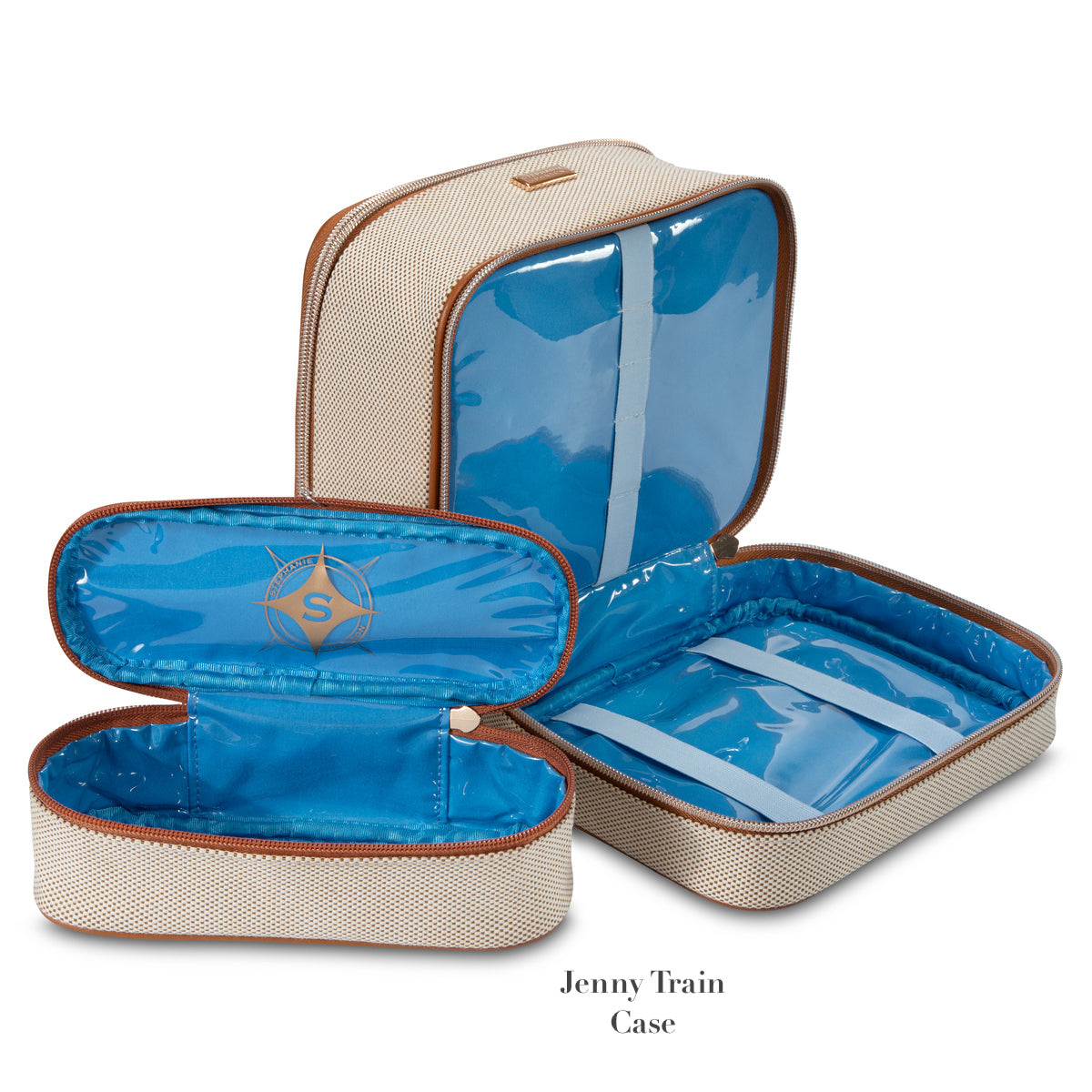 Two beige fabric travel cases from the Stephanie Johnson Tropea Travel Collection, with brown trim and blue lining—one open, one closed—offer removable compartments inspired by the Martha Large Cosmetic Case for organized storage.
