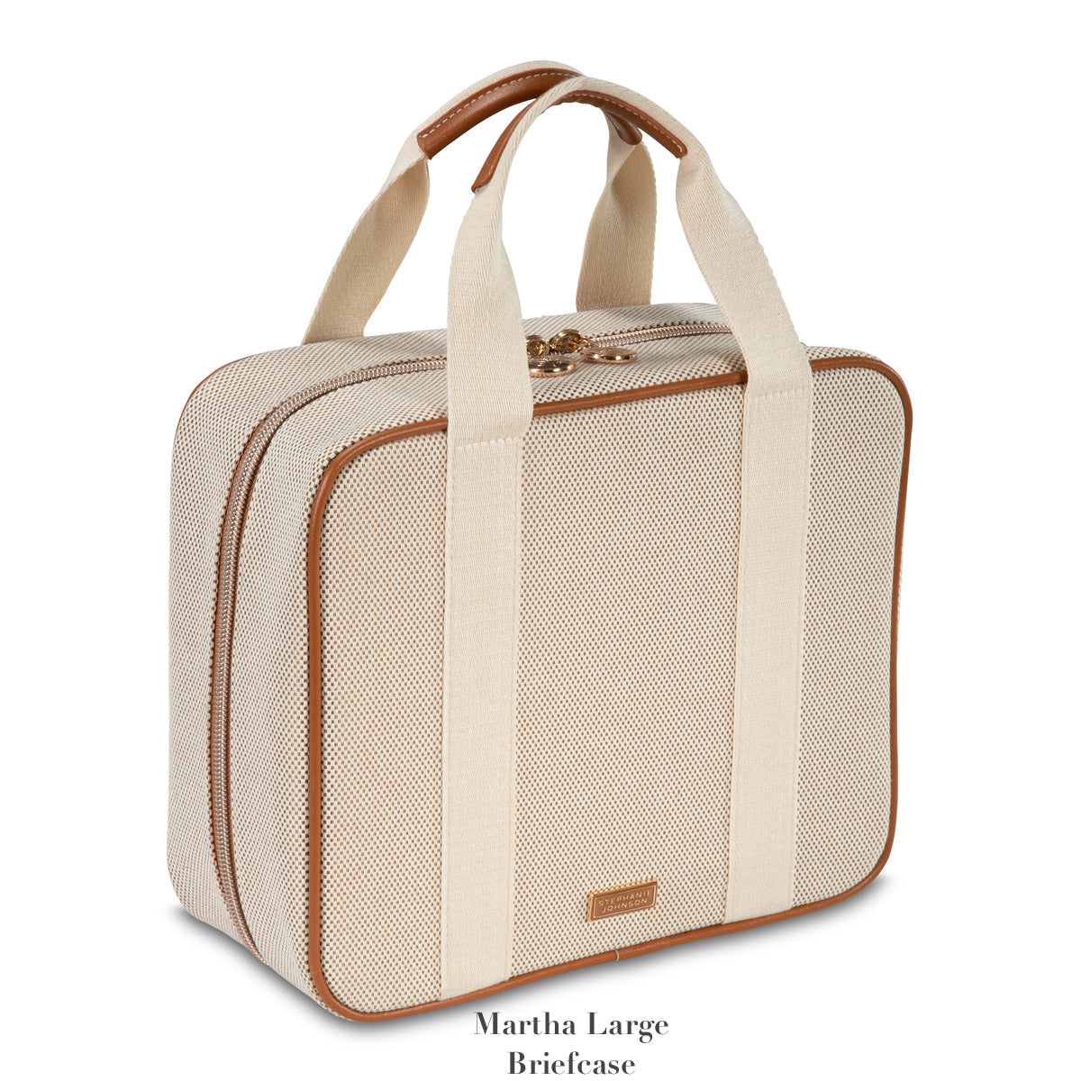 The Tropea Travel Collection by Stephanie Johnson is a beige and tan fabric briefcase with brown trim, two short handles, a zip closure, and removable compartments for versatile use.