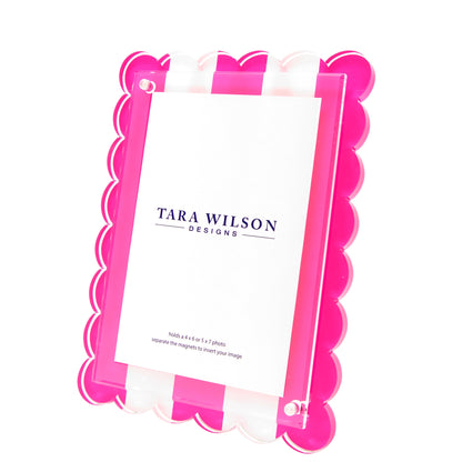 The Tara Wilson Scallop Stripe Frame by Tara Wilson Designs features pink and white stripes with a scalloped edge, making it a best-selling statement piece for any space.
