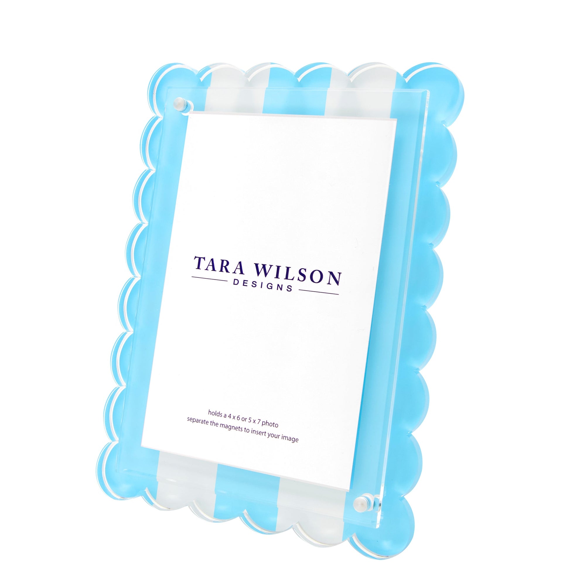 The Scallop Stripe Frame by Tara Wilson Designs features blue and clear stripes and stands upright to display your favorite card or photo.