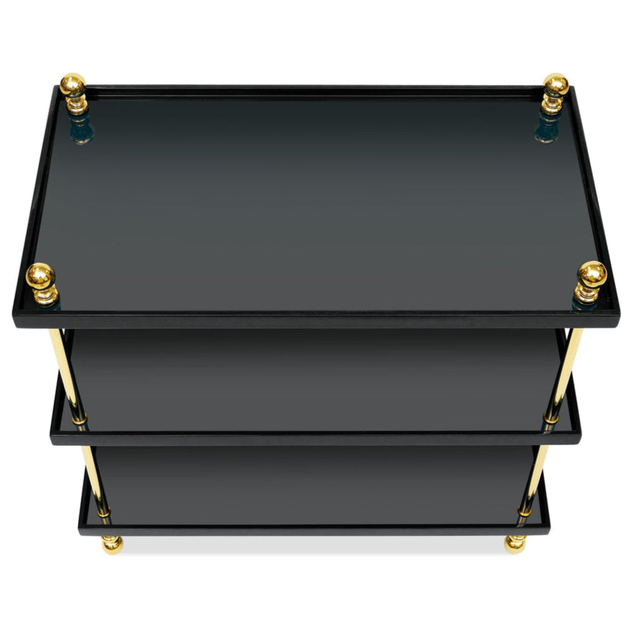 The Bunny Williams Tiered Drinks Table features three black glass shelves, gleaming brass posts, and gold sphere accents at each corner, shown from above.