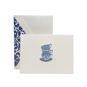 The Crane Tea Cups Card Set includes pearl white folded notes with an illustration of three stacked blue teacups and saucers, each paired with a blue and white toile-lined envelope—ideal for thoughtful thank-you notes.