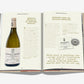 Open to a page from "The 100 Burgundy: Exceptional Wines To Build A Dream Cellar" by Assouline, featuring Meursault-Perrières with detailed notes and quotes—ideal for Burgundy wine aficionados and collectors.