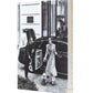 A doorman opens a car door as someone in a long coat walks a small dog outside The Peninsula London by Assouline, an iconic luxury hotel near Hyde Park.