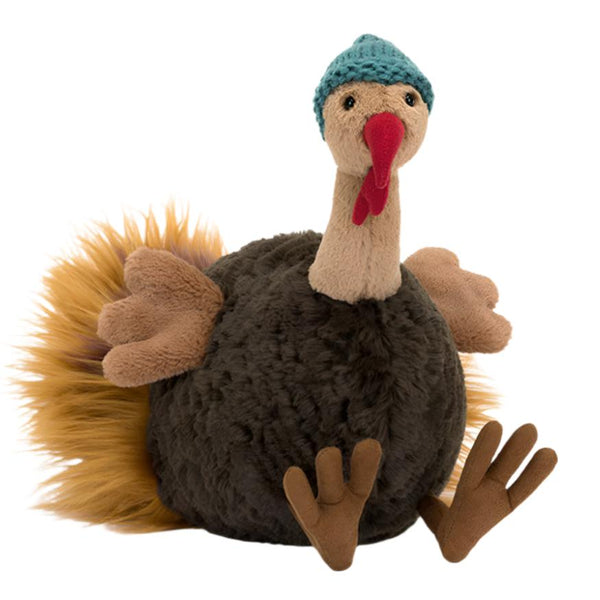 Meet the Jellycat Theo Turkey, a plush turkey toy from the Jellycat brand that features a fluffy body, yellow tail feathers, and brown wings. He sports a blue knitted winter hat on his head and sits with his legs stretched out, making him the perfect holiday gift for any occasion.