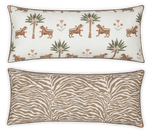 The Matouk Reversible Lumbar Pillow Collection offers versatile home decor with one side featuring tigers, palm trees, and flowers on white, and the other a tan and white zebra stripe pattern.