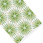 Radiant Bath Collection by Haute Home—white Italian linen fabric featuring a repeating pattern of green palm leaf shapes arranged in rows, photographed from an angled top-down perspective; an elegant choice for sophisticated home décor.