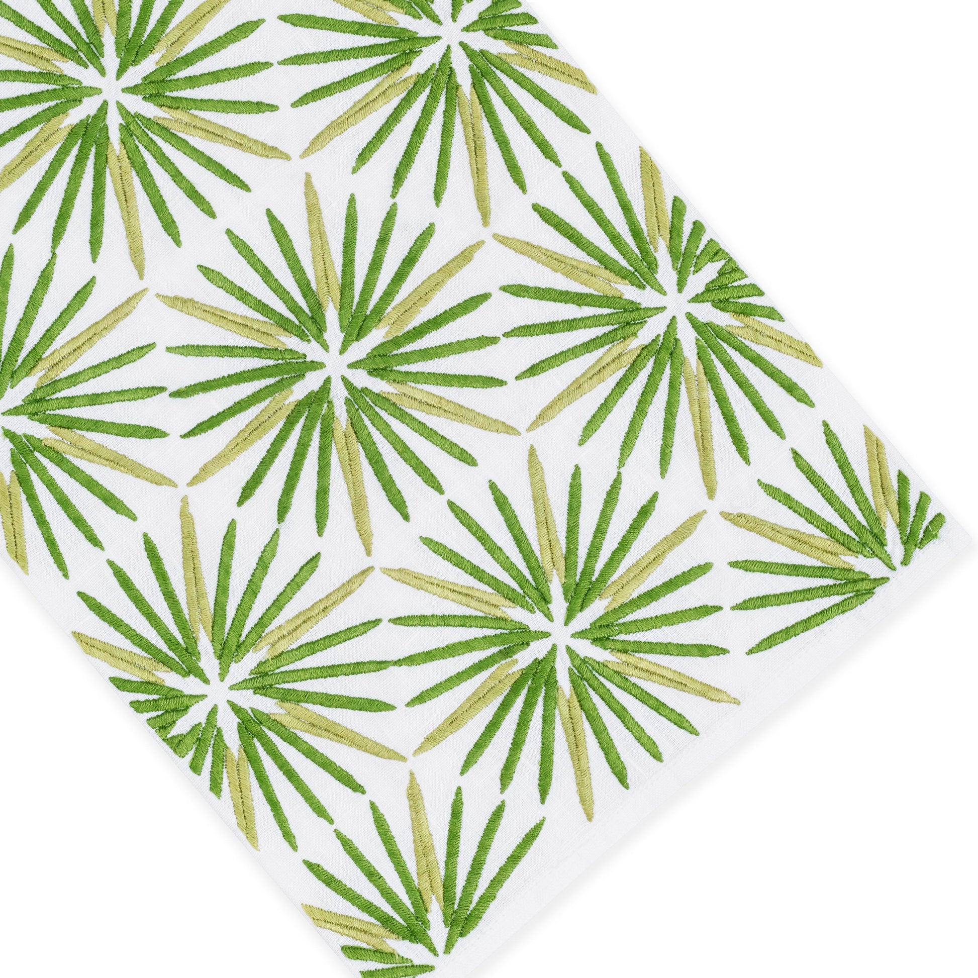 Radiant Bath Collection by Haute Home—white Italian linen fabric featuring a repeating pattern of green palm leaf shapes arranged in rows, photographed from an angled top-down perspective; an elegant choice for sophisticated home décor.
