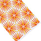 White surface with an angled pattern of orange and yellow starburst shapes evenly spaced across the image, evoking the timeless elegance of premium linen for refined home décor in the Haute Home Radiant Bath Collection.