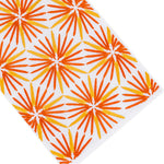 White surface with an angled pattern of orange and yellow starburst shapes evenly spaced across the image, evoking the timeless elegance of premium linen for refined home décor in the Haute Home Radiant Bath Collection.