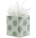 The Damini Sage Tissue Box Cover by John Robshaw features a hand block printed sage green rosette floral design, finished with delicate hand-stitched edging, and is shown holding white tissues emerging from the top.