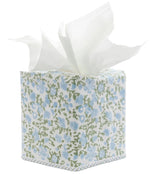 The Ekisha Tissue Box Cover by John Robshaw is a hand block printed piece inspired by Jaipur, showcasing a blue and green floral pattern with several white tissues pulled out from the top.