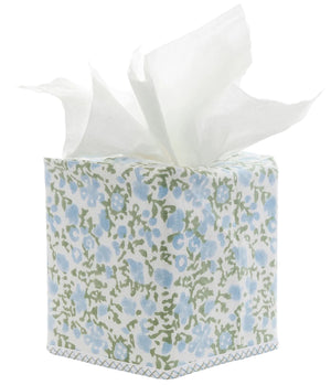 The Ekisha Tissue Box Cover by John Robshaw is a hand block printed piece inspired by Jaipur, showcasing a blue and green floral pattern with several white tissues pulled out from the top.