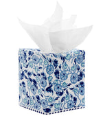The Ipsita Indigo Tissue Box Cover by John Robshaw features a hand block printed blue floral pattern inspired by coastal India decor, with partially pulled white tissues on top. This elegant blue vines tissue box cover adds a refreshing touch to any space.