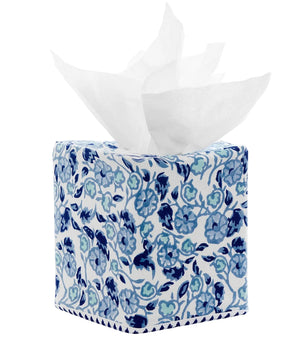 The Ipsita Indigo Tissue Box Cover by John Robshaw features a hand block printed blue floral pattern inspired by coastal India decor, with partially pulled white tissues on top. This elegant blue vines tissue box cover adds a refreshing touch to any space.