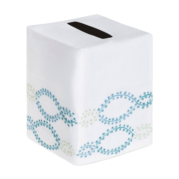 The Foam Bath Collection, Aqua by Haute Home features a hand-embroidered tissue box cover with decorative blue and green swirl patterns on Italian linen and a sleek black dispensing slit for easy access.