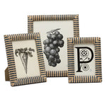 Three striped raffia Toluca Frame Collection pieces by Pigeon & Poodle showcase black-and-white illustrations of a carrot, grapes, and a decorative letter "P".