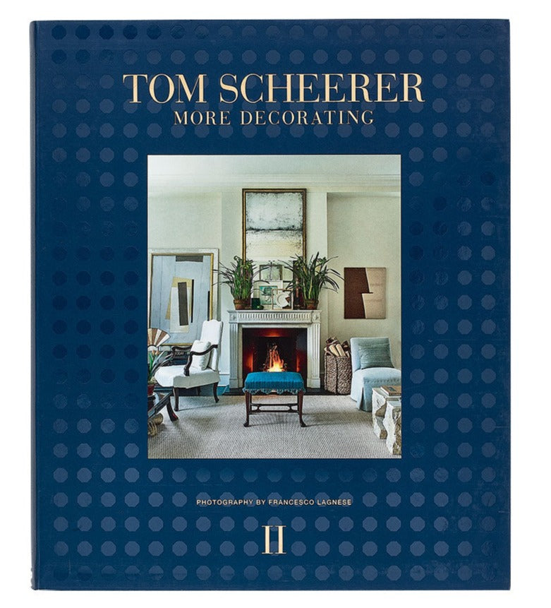 A book titled "The Tom Scheerer Compendium" by Vendome showcases American interior design with a living room scene on the cover. It features modern furnishings, art, a fireplace, and photography by Francesco Lagnese, epitomizing Tom Scheerer's signature Relaxed Modernism.