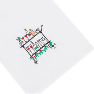The Holiday Bar Cart Tip Towel by Haute Home is a white cotton pique cloth (20 x 25) featuring an illustrated bar cart with bottles, glasses, and greenery accents.
