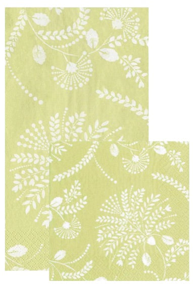 Two Trailing Floral Pale Green napkins by Caspari, featuring a white botanical leaf and fern design, with one napkin partially overlapping the other.