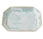 The Brushstroke Tray Collection by Paul Schneider Ceramics features a rectangular ceramic tray with gently rounded corners and a light blue and white speckled glaze inspired by modern design.