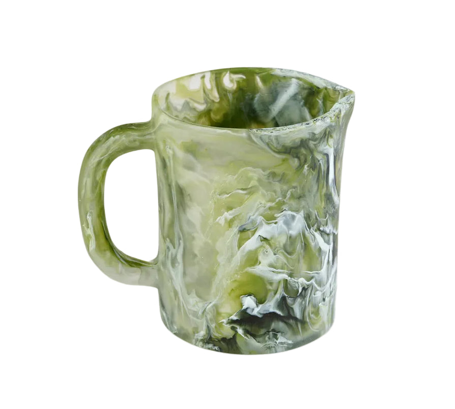 The Nashi Home Serveware Collection, Forest by Nashi Home features a handled ceramic pitcher with a green, white, and black marbled pattern—perfect as a striking home decor accent or unique serving piece. Shown against a white background.