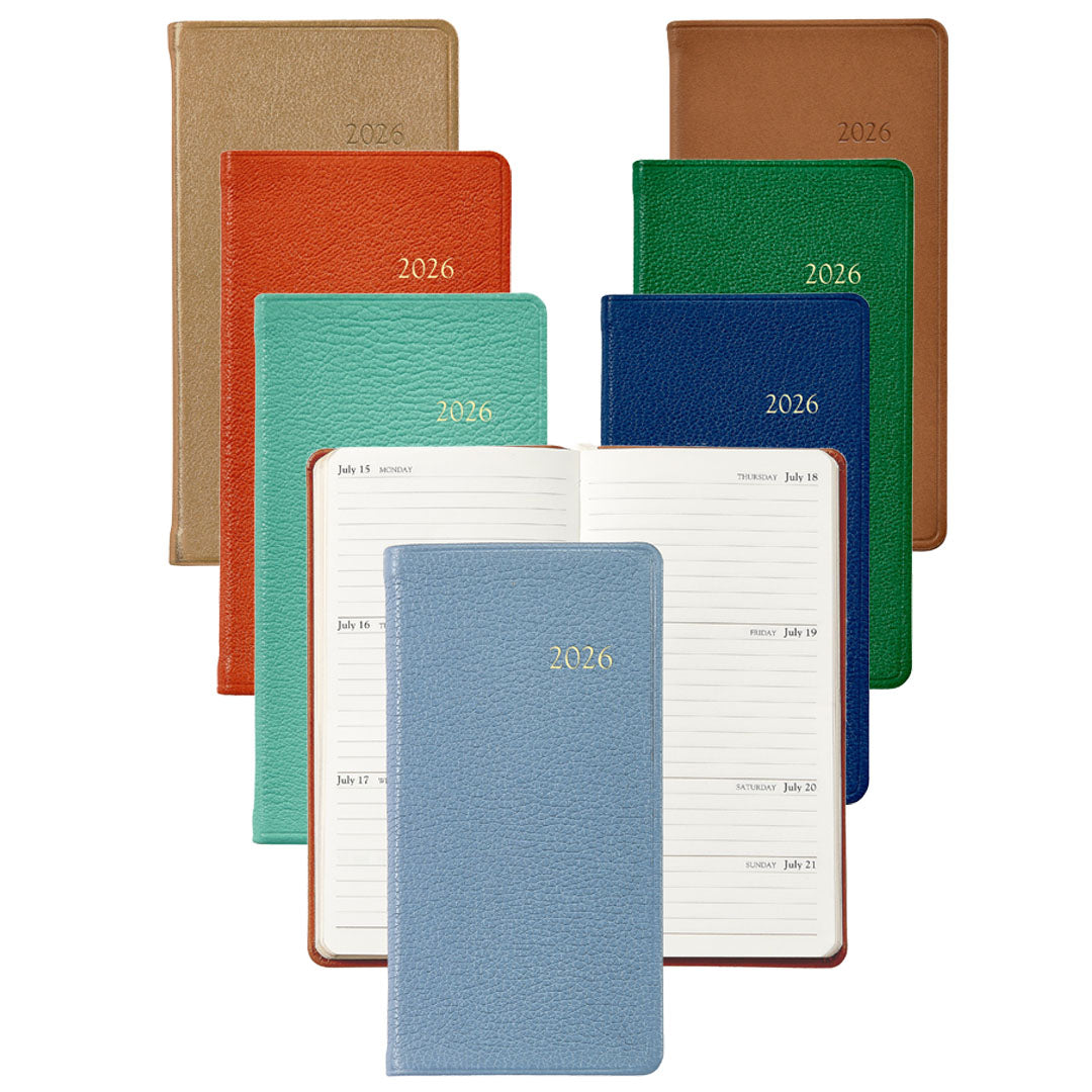 Eight planners from the 2026 Pocket Journal Planner Collection by Graphic Image are displayed in various colors, with one open to show lined pages for July 13–19—ideal as a personal pocket journal or Smyth sewn diary.