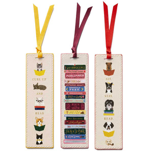 The Rifle Paper Co. Bookmark Collection includes three illustrated bookmarks with grosgrain ribbons: cats reading, classic books stack, and dogs reading—all in a whimsical design with unique reading-themed phrases at the bottom.