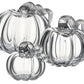 Three Simon Pearce Glass Pumpkins with a Twist, featuring textured stems, are arranged together on a white background for elegant autumn decor inspired by the New England harvest.