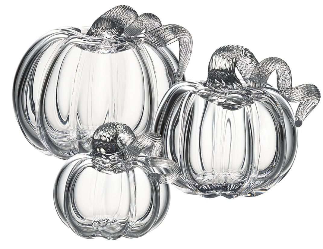 Three Simon Pearce Glass Pumpkins with a Twist, featuring textured stems, are arranged together on a white background for elegant autumn decor inspired by the New England harvest.