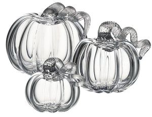 Three Simon Pearce Glass Pumpkins with a Twist, featuring textured stems, are arranged together on a white background for elegant autumn decor inspired by the New England harvest.