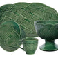 The Juliska Le Panier Mystic Knot Basil Dinnerware and Serveware Collection features plates, a mug, and a bowl with an intricate braided rope pattern—ideal for holiday gatherings or stylish ceramic serveware.