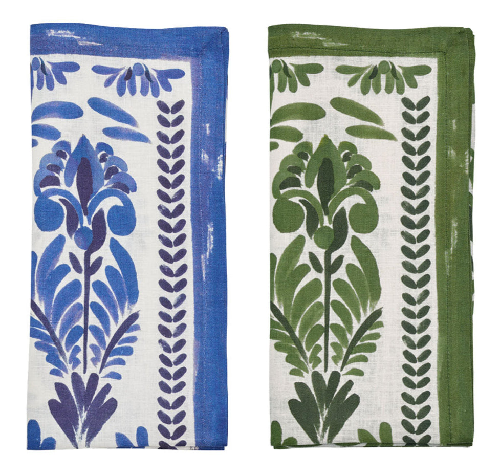 The Botanica Napkin Set by Kim Seybert features two folded napkins with botanical prints—one blue with purple, the other green with dark green on white—ideal as vintage-inspired table décor or elegant floral print linen napkins.