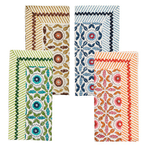 The Majorelle Napkin Set by Kim Seybert includes four handcrafted rectangular napkins with floral and leaf designs in brown, blue, green, and red, accented by matching diagonal stripes—each inspired by traditional Indian block printing.