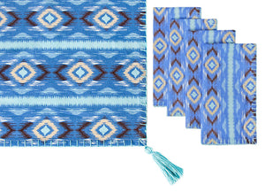 The Diamond Ikat Clearwater Table Linen Collection by Figue features a blue patterned table runner with a tasseled corner and four coordinating metallic blanket stitch napkins, ideal for a vibrant tablescape.