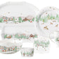 Berry & Thread North Pole Serveware Collection white ceramic holiday dinner plates featuring festive winter village scenes with pine trees, reindeer, and snowy mountains.